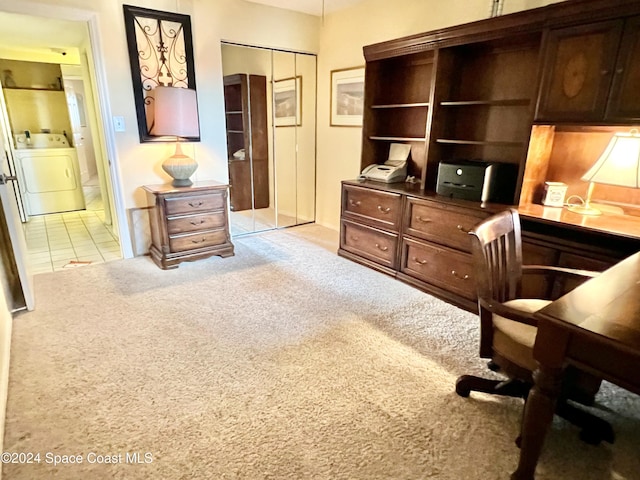 carpeted office space featuring washer / dryer