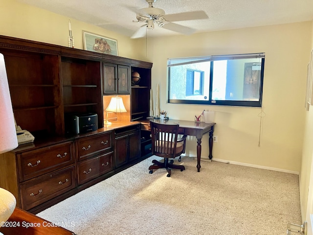 office with ceiling fan and a textured ceiling