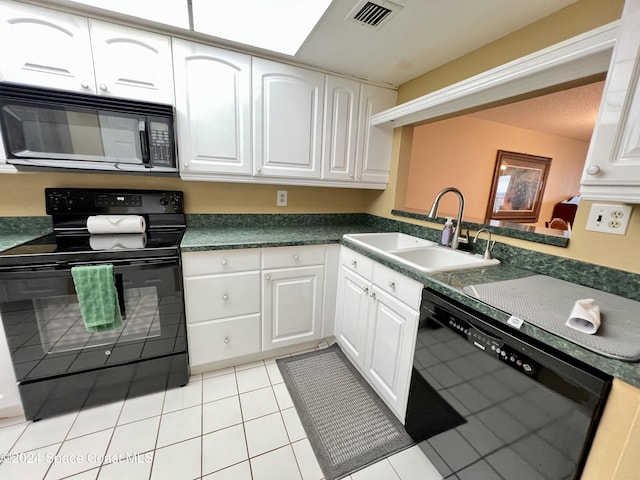 kitchen featuring sink, white cabinets, black appliances, and light tile patterned floors