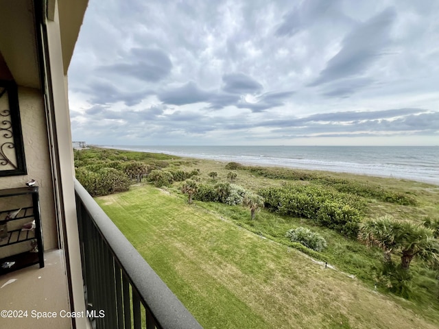 balcony featuring a water view and a view of the beach