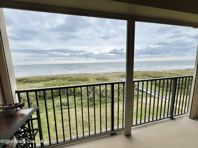 balcony with a beach view and a water view