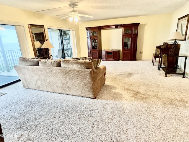 3170 N Atlantic Ave Unit 502, Cocoa Beach, FL 32931 - living area featuring carpet flooring, healthy amount of natural light, and a ceiling fan