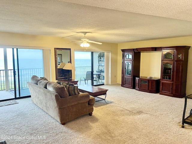 3170 N Atlantic Ave Unit 502, Cocoa Beach, FL 32931 - carpeted living area with ceiling fan and a textured ceiling