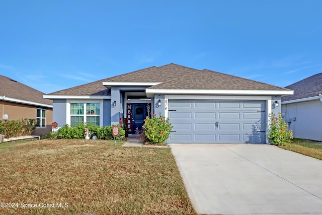 view of front of house with a front lawn and a garage