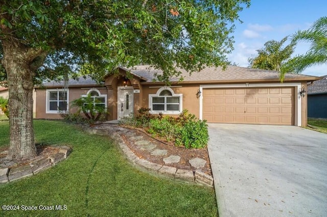 ranch-style home featuring a garage and a front lawn