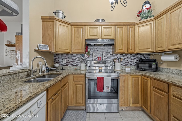 kitchen featuring dishwasher, sink, tasteful backsplash, light stone counters, and stainless steel electric range