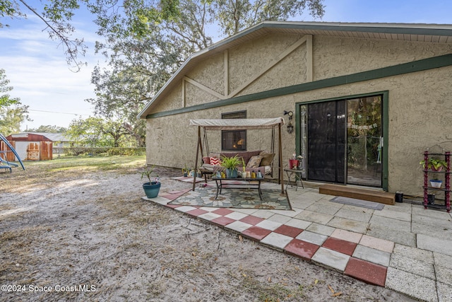 back of house featuring a patio and an outdoor hangout area