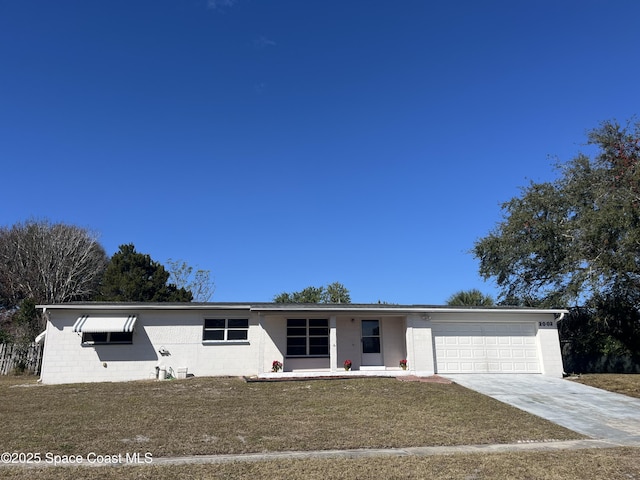 view of front of home with a front yard and a garage