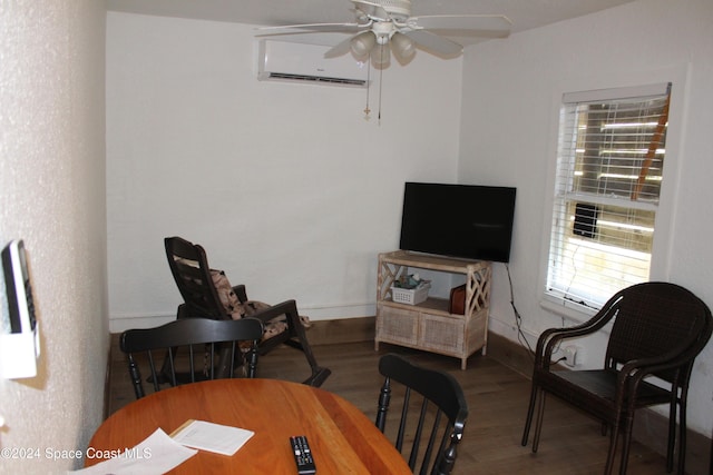 interior space with hardwood / wood-style flooring, a wall unit AC, and ceiling fan