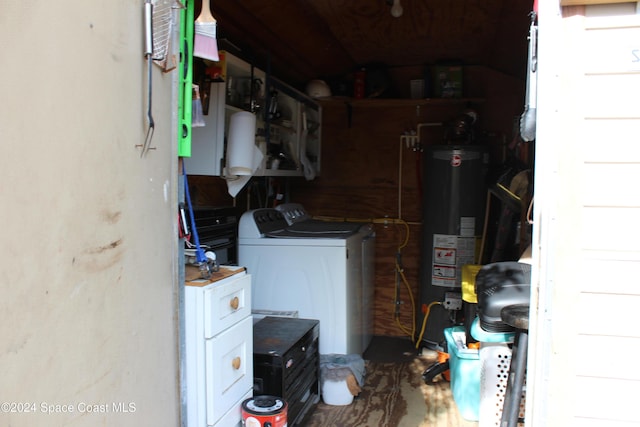 washroom with washing machine and dryer and water heater