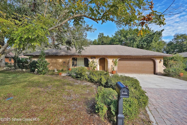 single story home featuring a front lawn and a garage