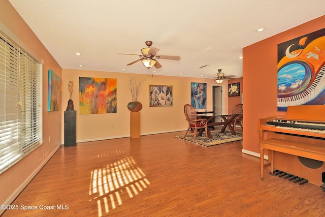 interior space with ceiling fan and hardwood / wood-style flooring