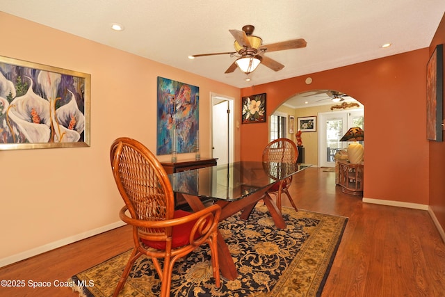 dining area featuring ceiling fan and dark wood-type flooring