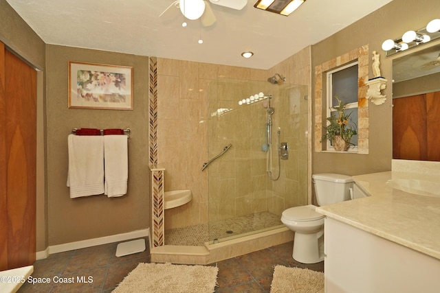 bathroom featuring ceiling fan, toilet, tiled shower, and vanity