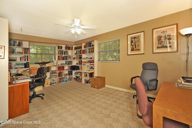 office space featuring ceiling fan, light colored carpet, and plenty of natural light