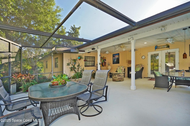 view of patio featuring ceiling fan, french doors, and a lanai