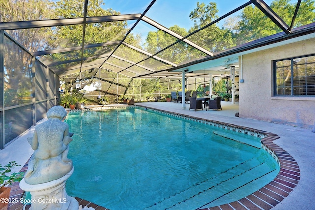 view of swimming pool with glass enclosure and a patio