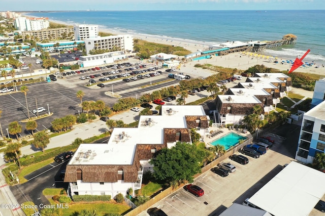 aerial view with a water view and a beach view