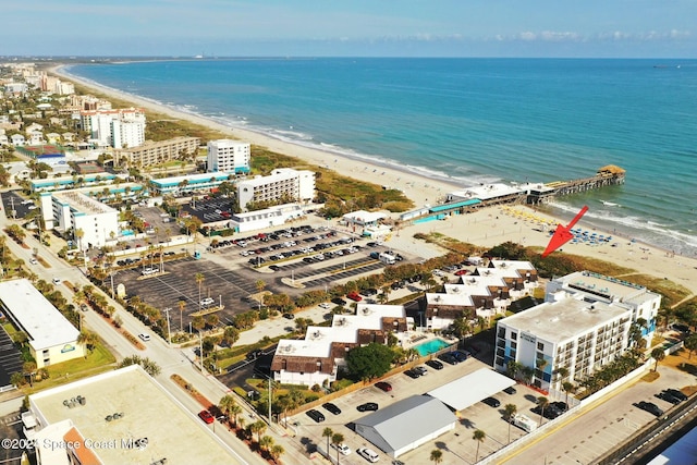 birds eye view of property with a water view and a view of the beach