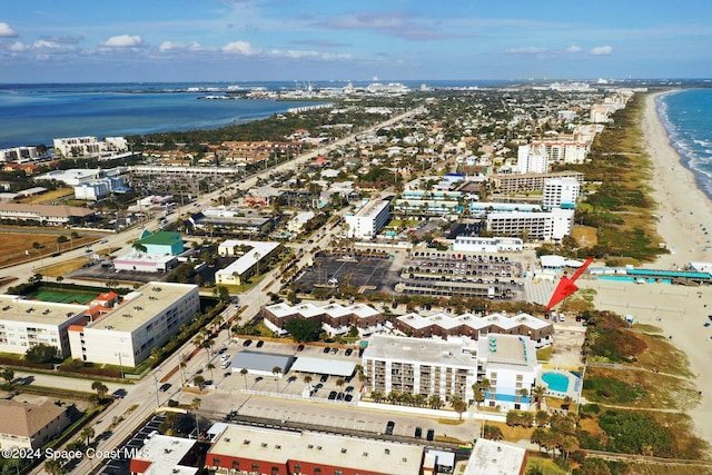 aerial view with a water view and a beach view