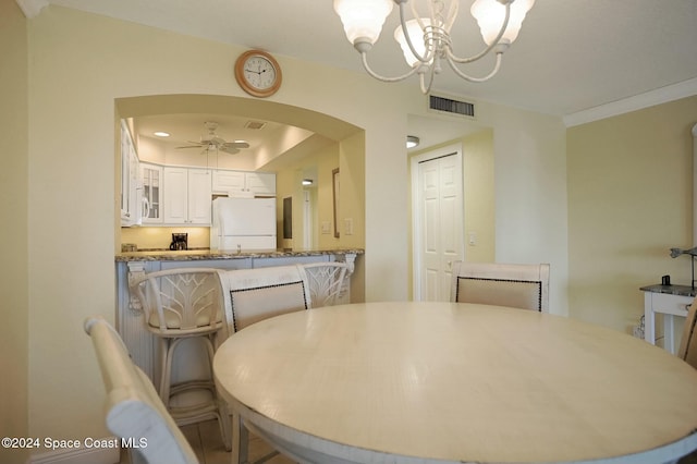 dining room featuring ceiling fan with notable chandelier