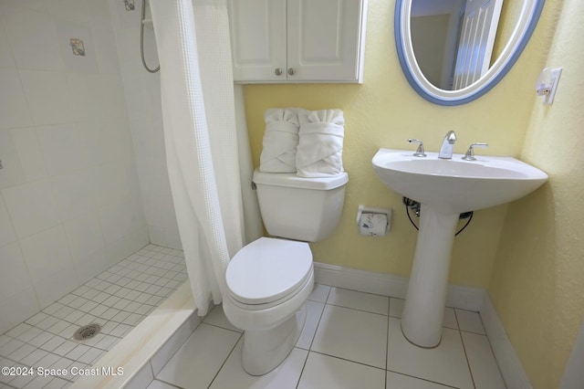 bathroom with tile patterned floors, curtained shower, and toilet