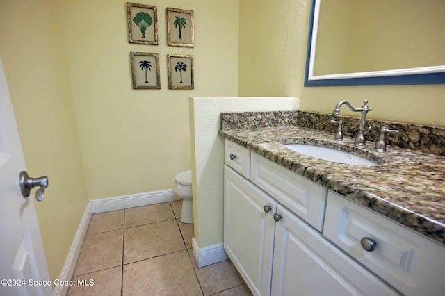 bathroom featuring tile patterned floors, vanity, and toilet