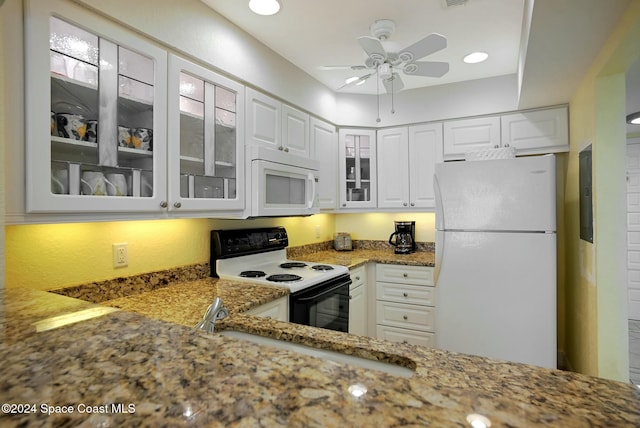 kitchen with white appliances, white cabinetry, ceiling fan, and light stone counters