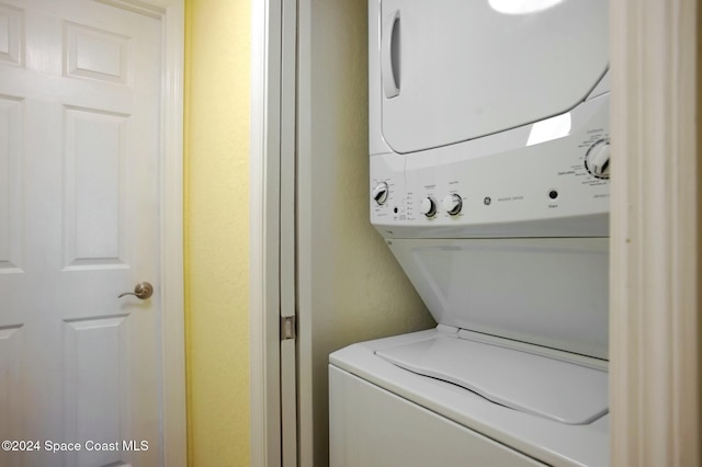 laundry room with stacked washing maching and dryer