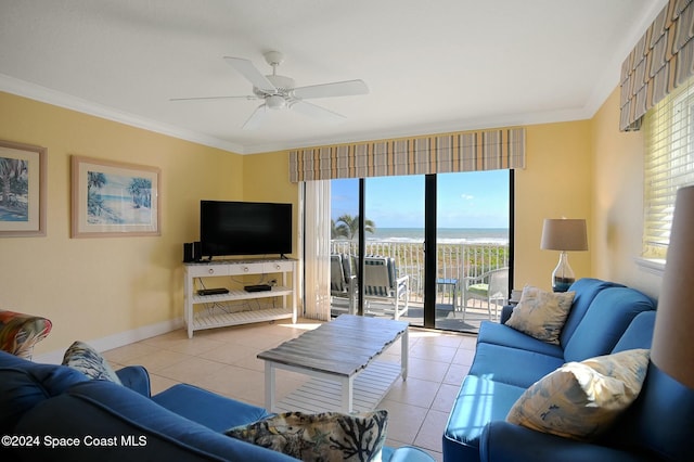 tiled living room with ceiling fan and ornamental molding