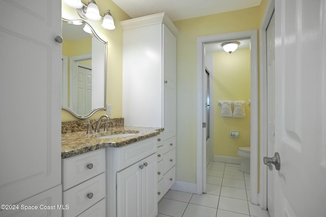 bathroom featuring tile patterned floors, vanity, and toilet