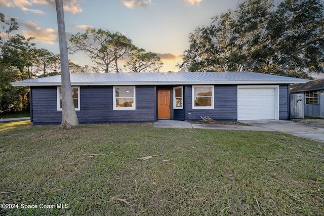 ranch-style home with a lawn and a garage