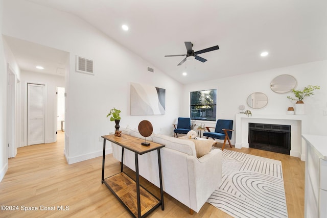 living room with vaulted ceiling, light hardwood / wood-style flooring, and ceiling fan