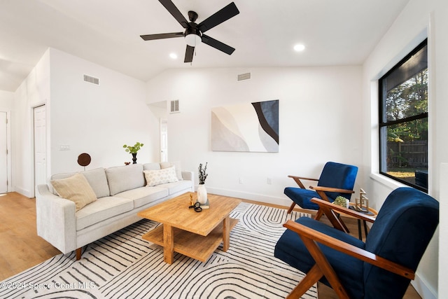 living room featuring light hardwood / wood-style floors, ceiling fan, and lofted ceiling