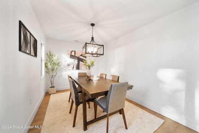 dining room with a notable chandelier and light hardwood / wood-style floors