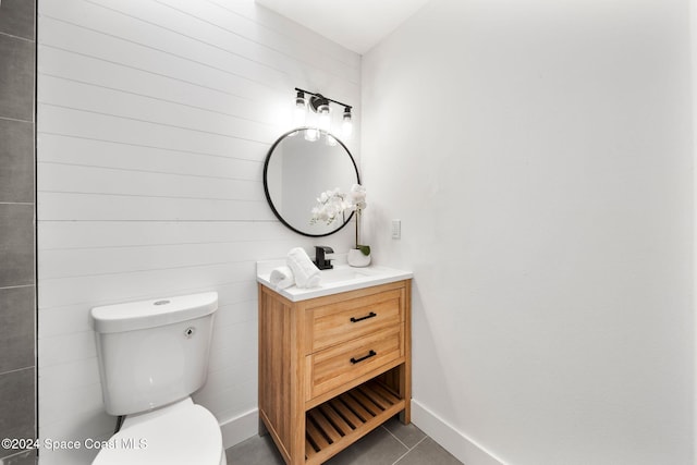 bathroom featuring tile patterned flooring, vanity, and toilet