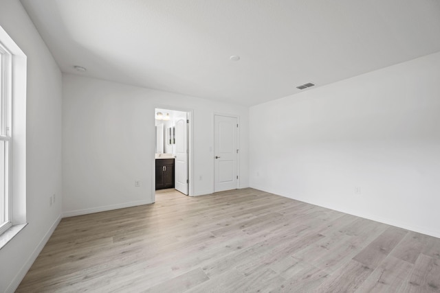 spare room featuring light wood-type flooring