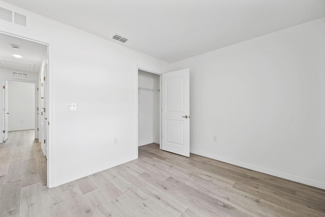 unfurnished bedroom featuring a closet and light hardwood / wood-style flooring