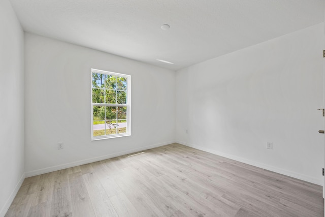 unfurnished room with light wood-type flooring