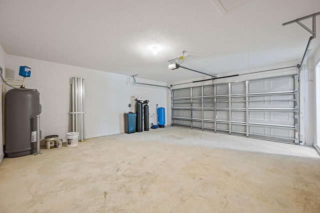 garage featuring electric water heater and a garage door opener