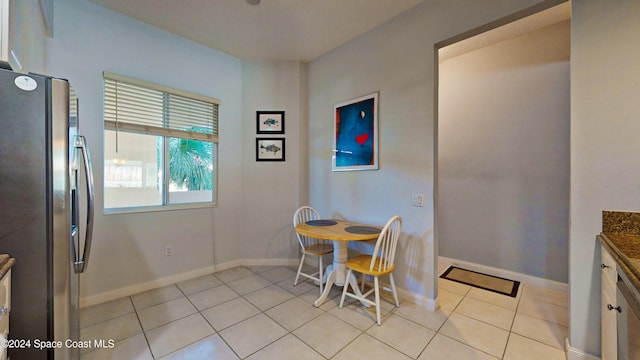 dining space featuring light tile patterned floors