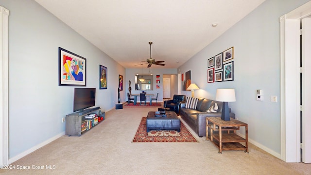 carpeted living room with ceiling fan