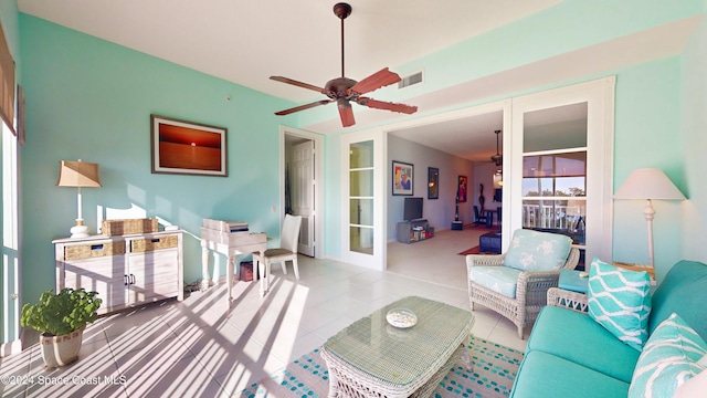 living room with light tile patterned floors, french doors, and ceiling fan