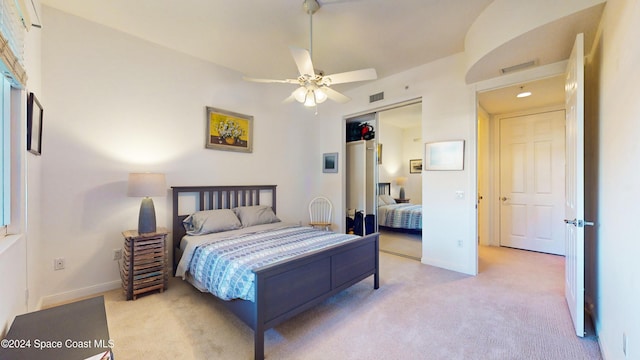 carpeted bedroom with ceiling fan and a closet