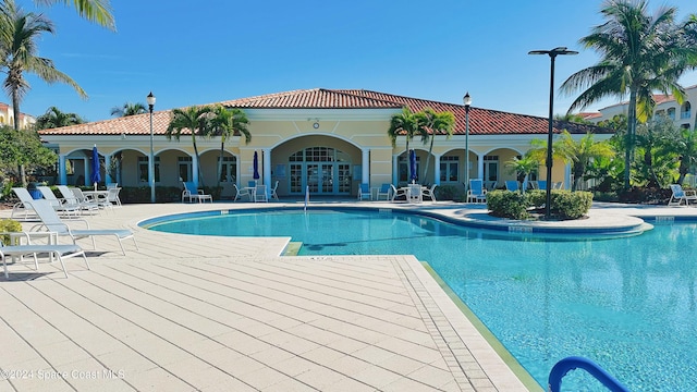 view of pool featuring french doors and a patio