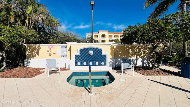 view of swimming pool featuring a community hot tub