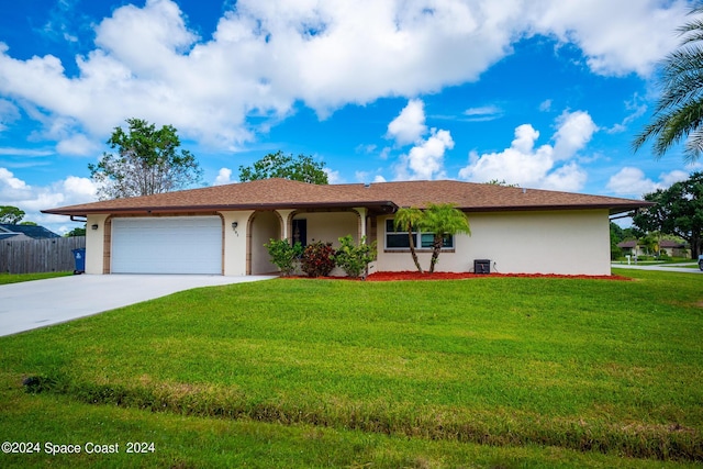 single story home with a garage and a front lawn