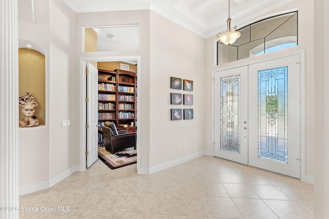 entrance foyer featuring coffered ceiling, ornamental molding, french doors, and light tile patterned flooring