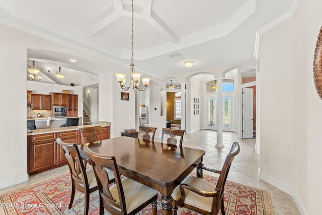 dining room with coffered ceiling, crown molding, light tile patterned floors, a raised ceiling, and decorative columns