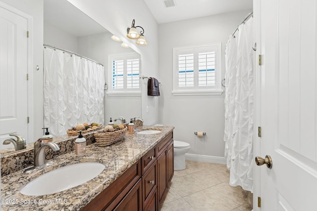 bathroom featuring tile patterned flooring, vanity, and toilet